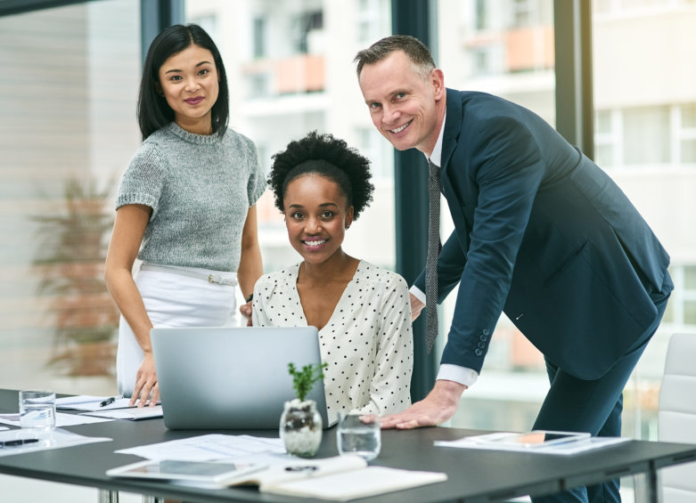 man talking to his two female colleagues